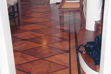 Inspiration for a mid-sized modern medium tone wood floor entryway remodel in New York with white walls and a white front door