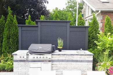 Example of a transitional backyard patio design in Toronto