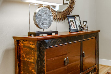 Inspiration for an eclectic entryway in Dallas with light hardwood floors, beige walls and brown floor.
