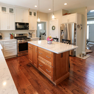Two-tone white kitchen with chestnut island and quartz countertops