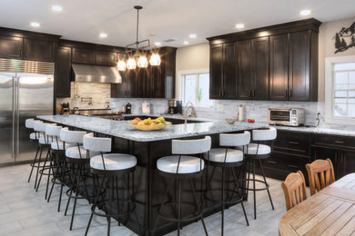 Example of a minimalist eat-in kitchen design in Baltimore with an island