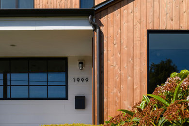 Inspiration for a modern two-storey house exterior in Seattle with mixed siding.