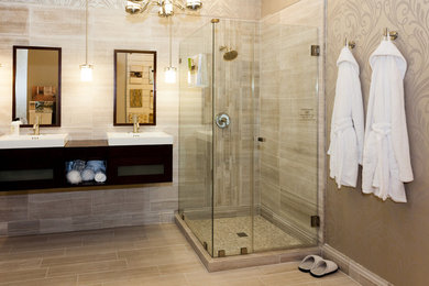Photo of a traditional bathroom in DC Metro with open cabinets, dark wood cabinets, gray tile, ceramic tile, marble benchtops, brown benchtops and a hinged shower door.