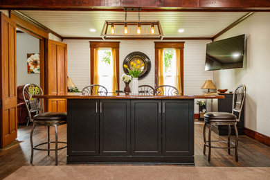 Example of a farmhouse u-shaped vinyl floor, multicolored floor and shiplap ceiling kitchen pantry design in Other with a double-bowl sink, shaker cabinets, medium tone wood cabinets, laminate countertops, multicolored backsplash, stone tile backsplash, black appliances, an island and white countertops