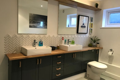 Bathroom - large contemporary kids' white tile and ceramic tile vinyl floor and gray floor bathroom idea in Sussex with shaker cabinets, turquoise cabinets, a one-piece toilet, white walls, a trough sink and laminate countertops