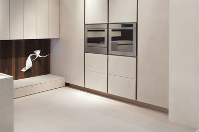 Inspiration for a contemporary porcelain tile closet remodel in San Diego with flat-panel cabinets and beige cabinets