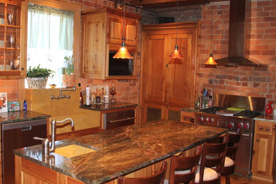Example of a kitchen design in Richmond with a farmhouse sink, raised-panel cabinets, granite countertops and stainless steel appliances