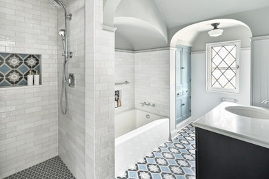 Bathroom - mid-sized transitional master gray tile and porcelain tile porcelain tile, blue floor, single-sink and wainscoting bathroom idea in Milwaukee with shaker cabinets, black cabinets, a two-piece toilet, gray walls, a drop-in sink, quartzite countertops, white countertops, a niche and a freestanding vanity