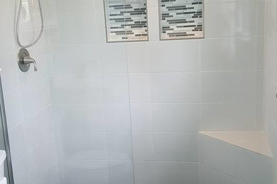 Example of a mid-sized minimalist master alcove shower design in Baltimore with shaker cabinets, white cabinets, blue walls and an undermount sink