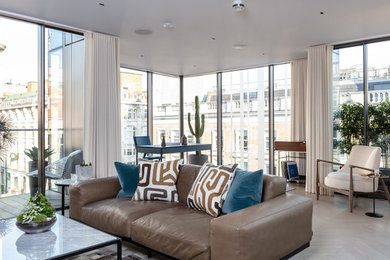 Photo of a large contemporary open plan living room in London with light hardwood flooring and beige floors.