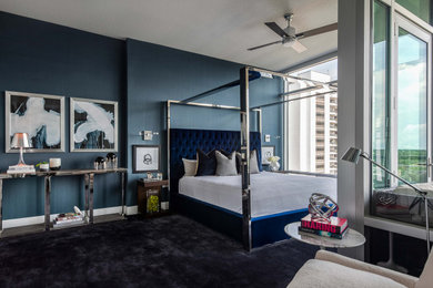 This is an example of a large modern master bedroom in Orlando with blue walls, carpet and blue floor.