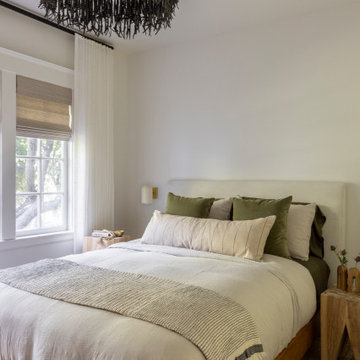 Bedroom with Wood Bedframe, Upholstered Headboard, and Layered Textiles