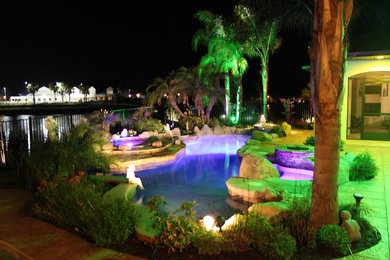 Inspiration for a small tropical backyard concrete paver and custom-shaped natural hot tub remodel in Orlando