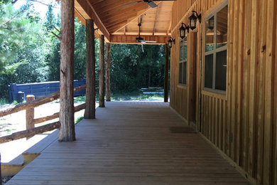 Large mountain style front porch idea in Other with decking and a roof extension