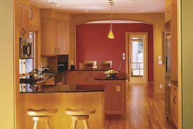 Kitchen - light wood floor kitchen idea in Portland Maine with light wood cabinets and granite countertops