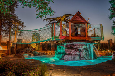 Huge mountain style backyard stone and custom-shaped natural pool fountain photo in Other