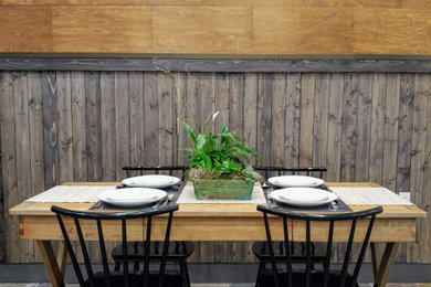 Inspiration for a wood wall dining room remodel in Other with brown walls