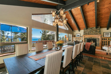 Great room - large rustic slate floor, gray floor and exposed beam great room idea in Other with beige walls, a stone fireplace and a standard fireplace