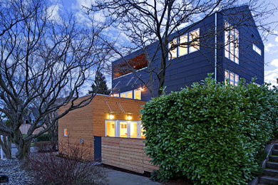 Inspiration for a contemporary three-story mixed siding gable roof remodel in Seattle with a metal roof