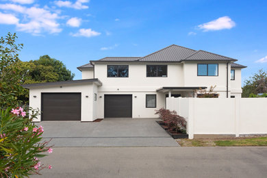 Design ideas for a contemporary two-storey stucco house exterior in Christchurch.