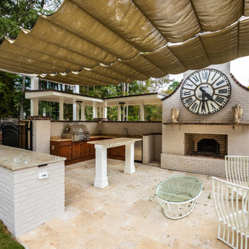 Elegant Outdoor Kitchen with Pergola, Fireplace & Statement Clock