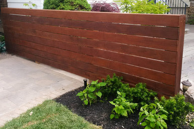 This is an example of a small modern full sun side yard concrete paver landscaping in Toronto for spring.