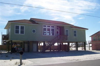 Inspiration for a large coastal blue two-story wood exterior home remodel in Miami with a shingle roof