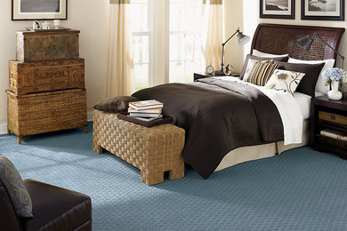 Mid-sized transitional guest carpeted and blue floor bedroom photo in Other with beige walls