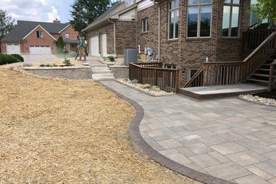 Inspiration for a small timeless backyard concrete paver patio remodel in Other with no cover