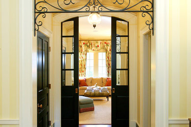 Inspiration for a mid-sized mediterranean hallway in St Louis with yellow walls and dark hardwood floors.