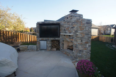 Inspiration for a large transitional backyard patio in Kansas City with a fire feature, concrete pavers and no cover.