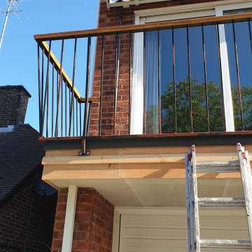 Front exterior - garage door, hand rail, and railing in West Wimbledon