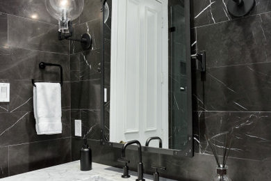 Example of a small classic 3/4 marble tile and black tile marble floor, single-sink, white floor and wall paneling alcove shower design in Dallas with furniture-like cabinets, gray cabinets, a one-piece toilet, an undermount sink, marble countertops, a hinged shower door, gray countertops, a niche, a freestanding vanity and black walls