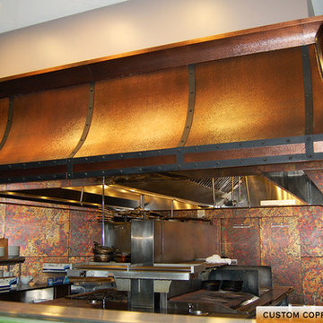Custom hammered copper range hood for a commercial restaurant.