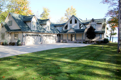 Inspiration for a mid-sized craftsman beige two-story vinyl exterior home remodel in Other with a shingle roof