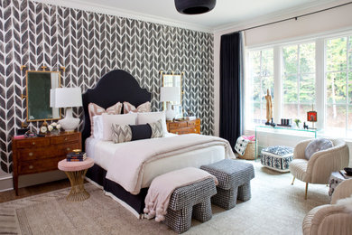 Example of a transitional master medium tone wood floor and brown floor bedroom design in Atlanta with pink walls and no fireplace