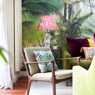 Large bohemian enclosed living room in London with multi-coloured walls, dark hardwood flooring and a concealed tv.