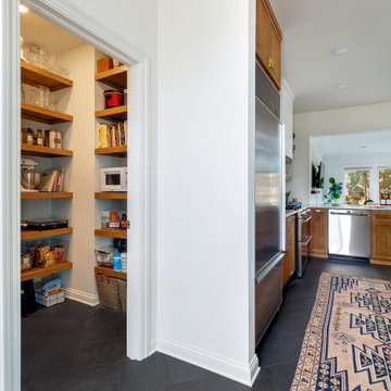 Open Kitchen Layout with Stained Reeded Cabinets & White Countertops