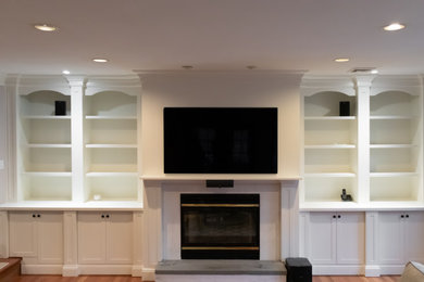 Large transitional family room photo in New York with a media wall