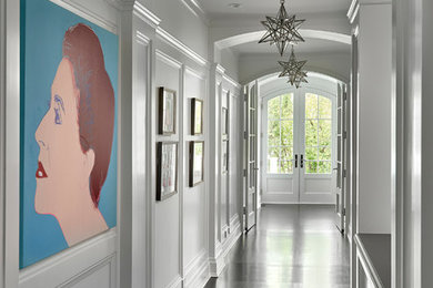 Inspiration for a mid-sized modern dark wood floor and brown floor hallway remodel in Chicago with white walls