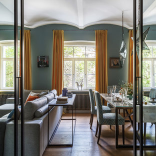 Пример оригинального дизайна: гостиная-столовая в стиле современная классика с синими стенами, паркетным полом среднего тона и коричневым полом