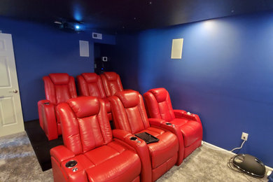 Home theater - mid-sized traditional enclosed carpeted and gray floor home theater idea in Philadelphia with blue walls and a projector screen