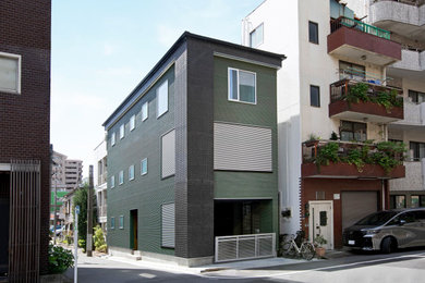 東京23区にある中くらいなおしゃれな家の外観 (緑の外壁、長方形) の写真