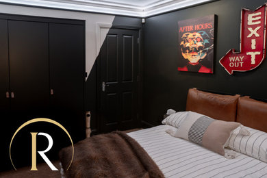 Photo of a contemporary cream and black bedroom in Essex with black walls, carpet, brown floors and feature lighting.