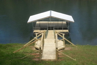 Inspiration for a mid-sized backyard dock remodel in Little Rock with a roof extension