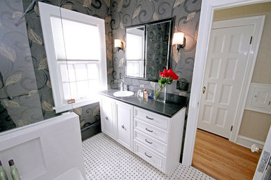 This is an example of a small traditional bathroom in Milwaukee with flat-panel cabinets, white cabinets, engineered quartz benchtops, white tile, ceramic tile, an alcove tub, a corner shower, a two-piece toilet, a drop-in sink, grey walls and mosaic tile floors.