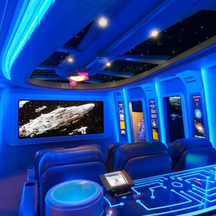 Home theater - large modern enclosed carpeted home theater idea in San Diego with blue walls and a projector screen