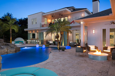 Inspiration for a huge contemporary backyard tile patio remodel in Orlando with a fire pit and a roof extension