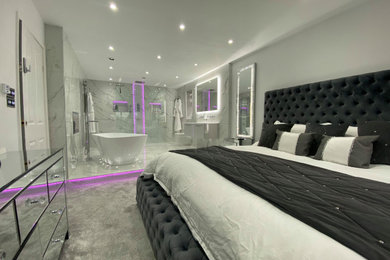 This is an example of a large modern grey and white ensuite bathroom in Other with white walls, porcelain flooring, white floors, flat-panel cabinets, grey cabinets, a freestanding bath, a walk-in shower, a wall mounted toilet, white tiles, an open shower, double sinks, a floating vanity unit and a drop ceiling.