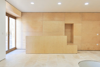 Réalisation d'une petite salle de séjour design ouverte avec un mur blanc, un sol en carrelage de céramique, aucune cheminée et un sol beige.